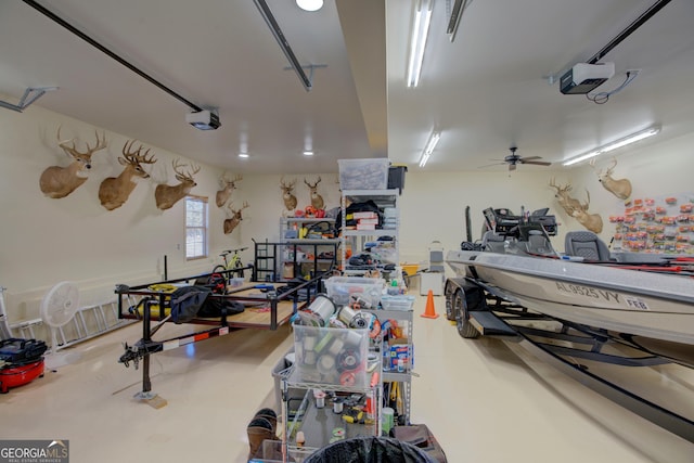 garage with a garage door opener and a workshop area