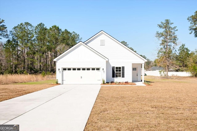 modern farmhouse featuring a garage, driveway, and a front yard