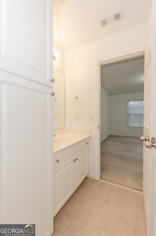 2474 Starfire Ln, Loganville, GA 30052 - bathroom featuring vanity, tile patterned floors, and baseboards