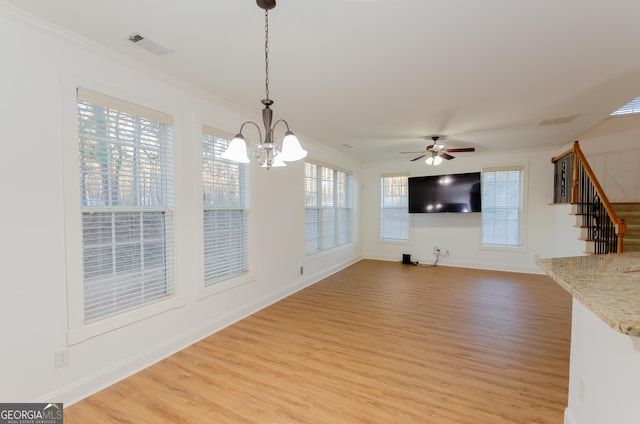 2474 Starfire Ln, Loganville, GA 30052 - unfurnished living room with light wood-style floors, a chandelier, stairs, ceiling fan, and baseboards