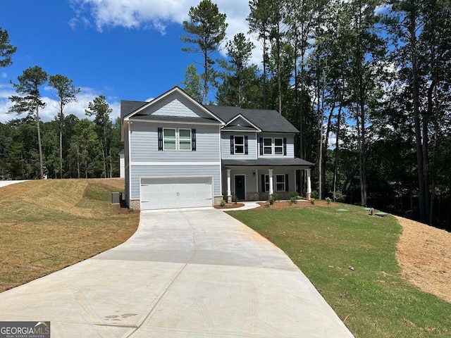 view of front of home with a garage, a porch, concrete driveway, and a front lawn