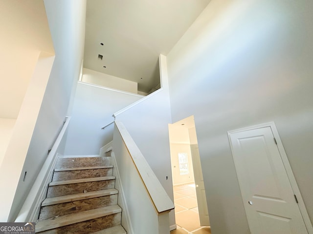 staircase with a high ceiling