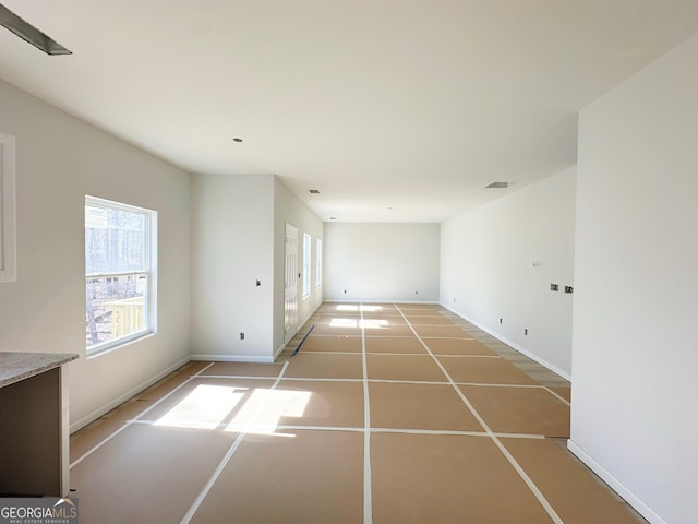 spare room with light tile patterned floors, visible vents, and baseboards