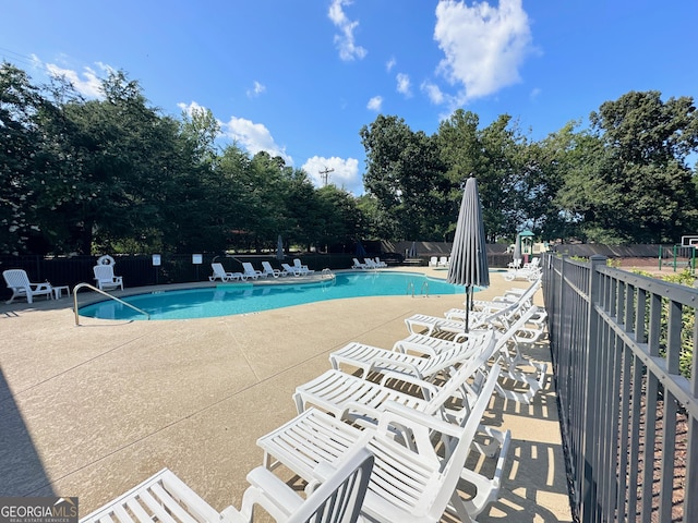 pool featuring a patio area and fence