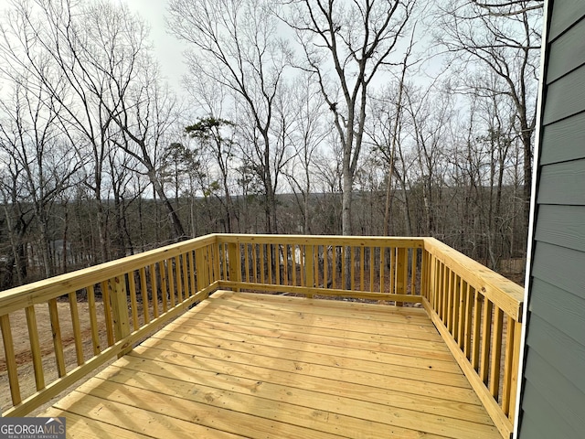 wooden terrace with a view of trees