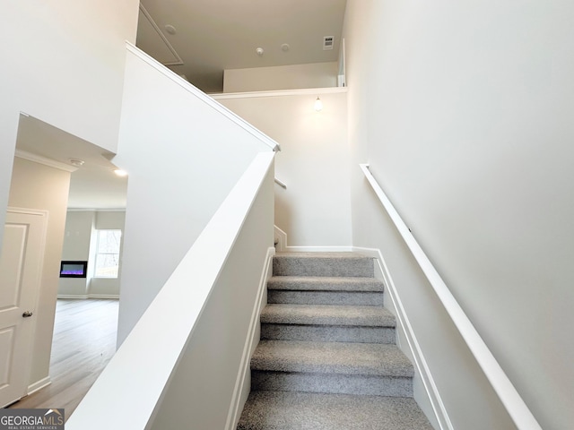 stairway featuring wood finished floors and baseboards