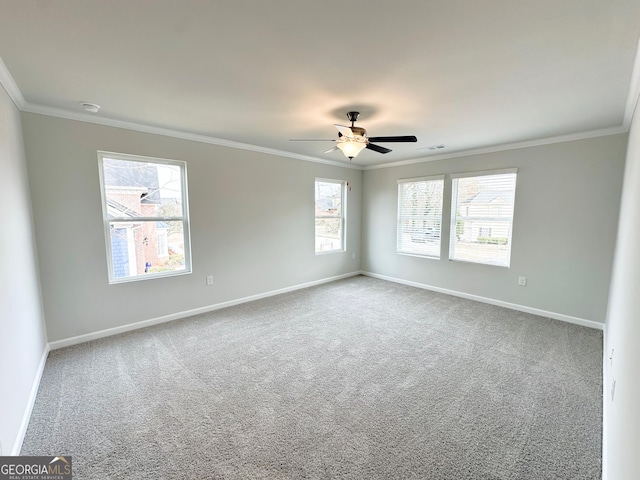 unfurnished room featuring a healthy amount of sunlight, baseboards, and crown molding