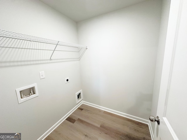 laundry room featuring hookup for a washing machine, hookup for an electric dryer, laundry area, wood finished floors, and baseboards