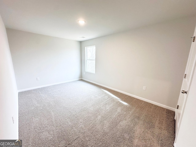 spare room with carpet floors and baseboards