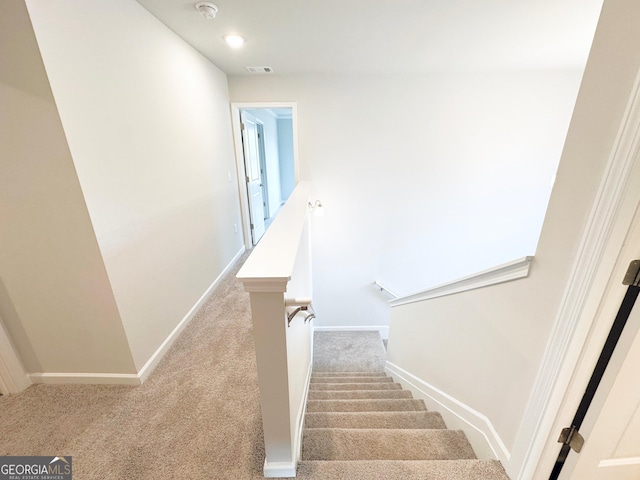 stairs with carpet floors, recessed lighting, visible vents, and baseboards