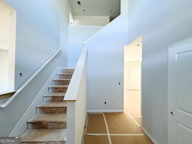 stairs featuring a high ceiling