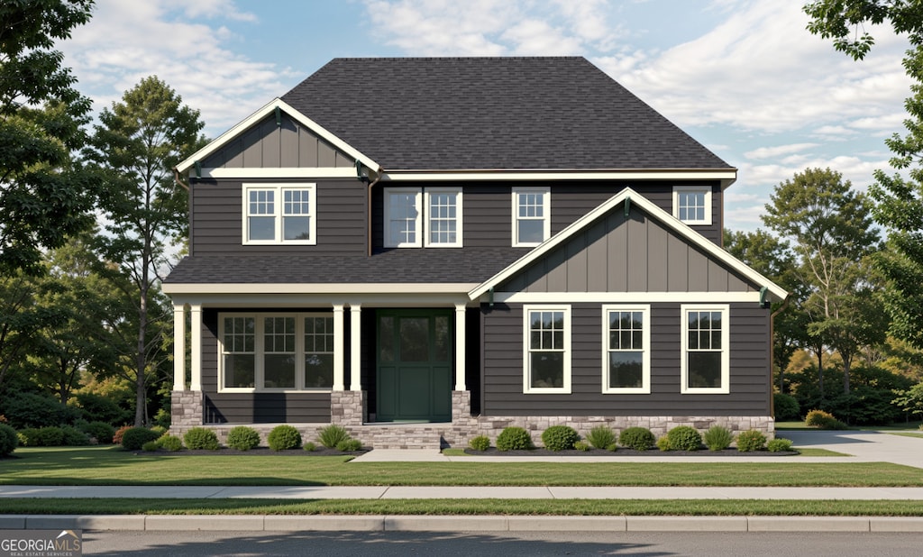 craftsman inspired home with roof with shingles, a front lawn, and board and batten siding