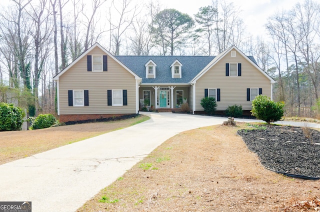 cape cod-style house featuring a porch