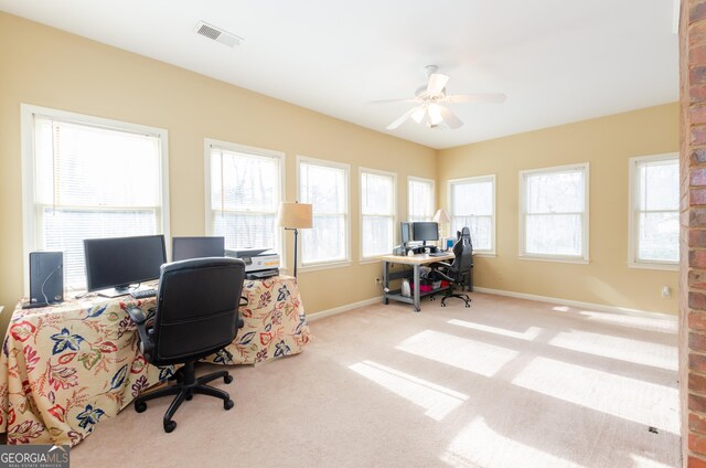 carpeted home office with baseboards, visible vents, and a ceiling fan