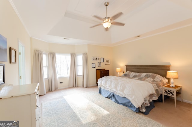 bedroom with crown molding, a raised ceiling, a ceiling fan, light carpet, and baseboards