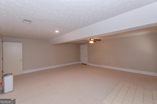 spare room with light carpet, visible vents, and baseboards