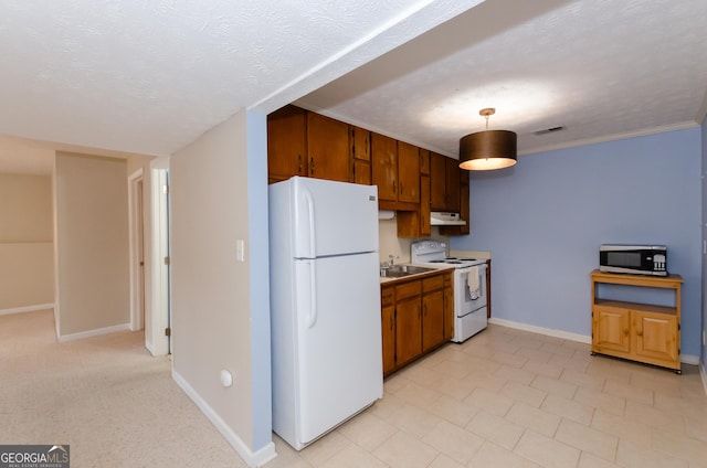 kitchen with white appliances, visible vents, a textured ceiling, and baseboards