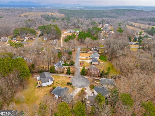 drone / aerial view featuring a view of trees