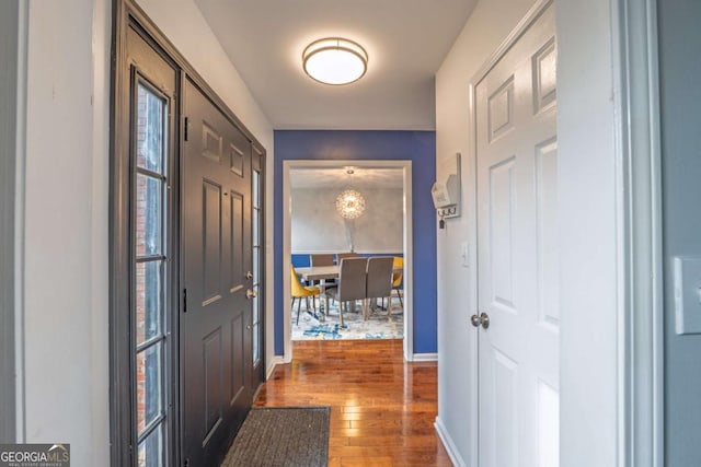 interior space featuring baseboards and hardwood / wood-style floors