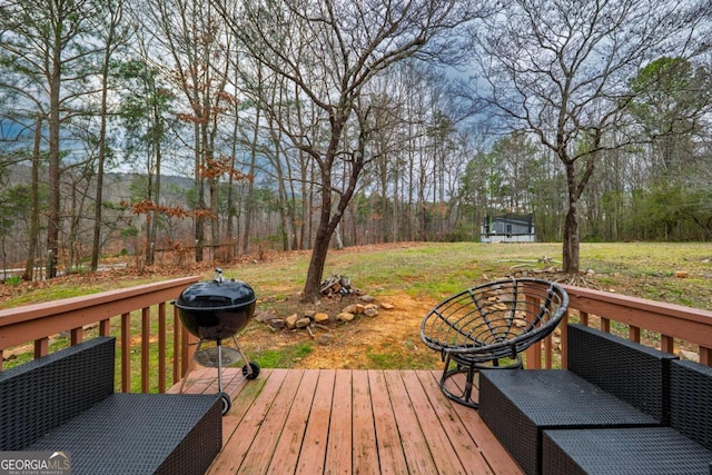 wooden deck featuring a lawn