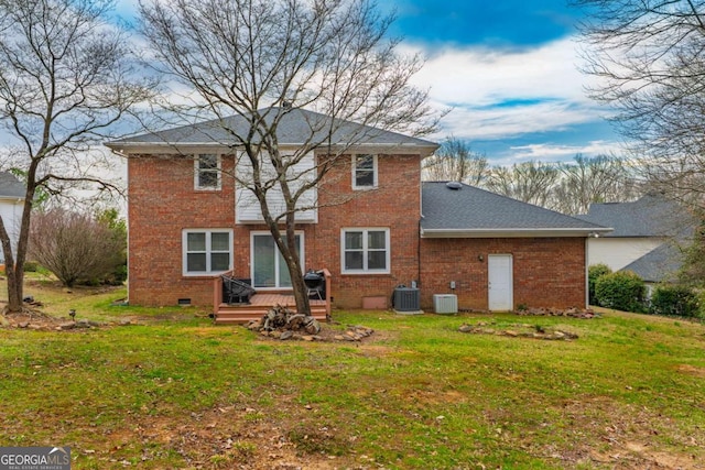 rear view of property featuring crawl space, brick siding, a lawn, and central air condition unit