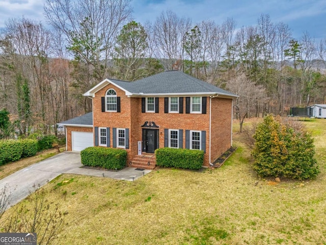 view of front facade featuring an attached garage, brick siding, concrete driveway, roof with shingles, and a front yard