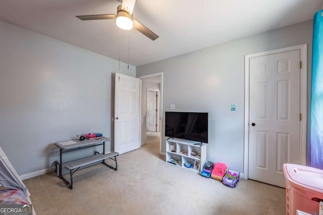 interior space with carpet floors, baseboards, and a ceiling fan