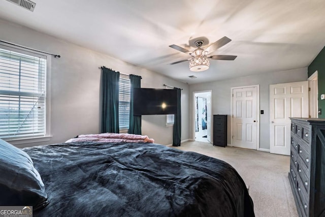 bedroom with visible vents, ceiling fan, light carpet, and baseboards