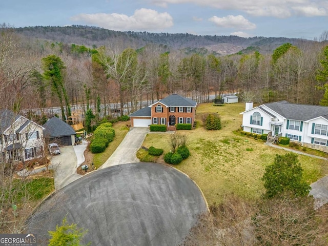 aerial view featuring a wooded view