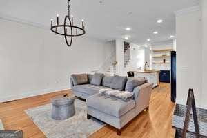 living area with stairway, recessed lighting, light wood-style flooring, and baseboards