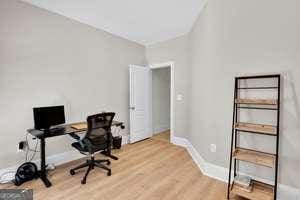 office with light wood-style flooring and baseboards