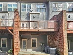 rear view of property with brick siding and central air condition unit