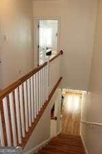 stairway with wood finished floors