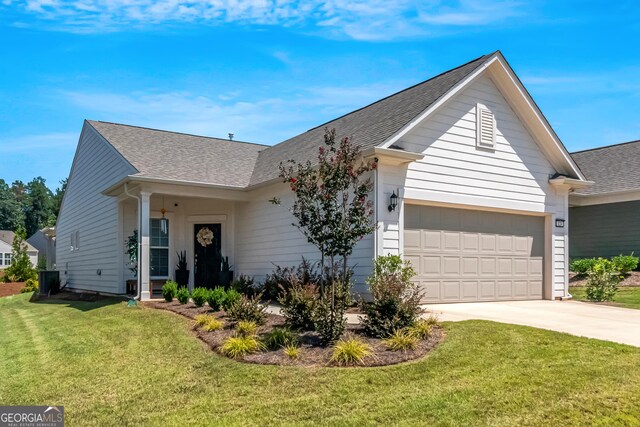 view of front of property featuring a garage, a front yard, and concrete driveway