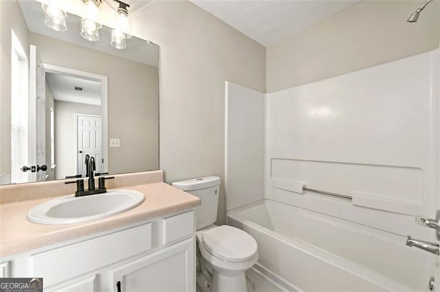 bathroom with shower / washtub combination, vanity, and toilet