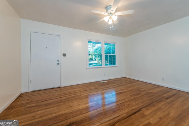 interior space with ceiling fan, baseboards, and wood finished floors