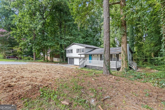 split level home with a garage and covered porch