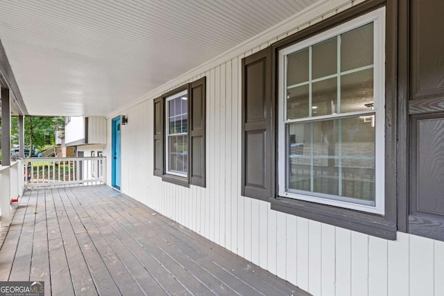 wooden terrace featuring covered porch