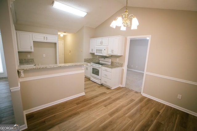 kitchen with decorative light fixtures, light wood finished floors, white cabinets, vaulted ceiling, and white appliances