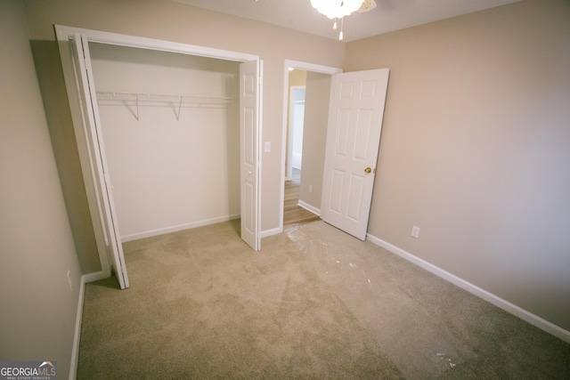 unfurnished bedroom featuring a closet, carpet, and baseboards