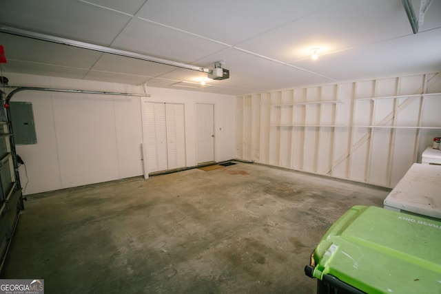 garage with electric panel and a garage door opener