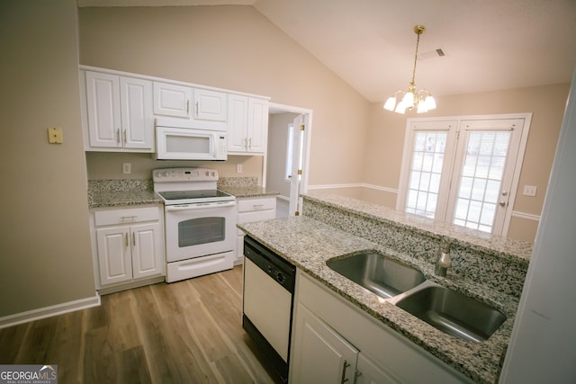 kitchen featuring visible vents, white cabinetry, vaulted ceiling, a sink, and white appliances