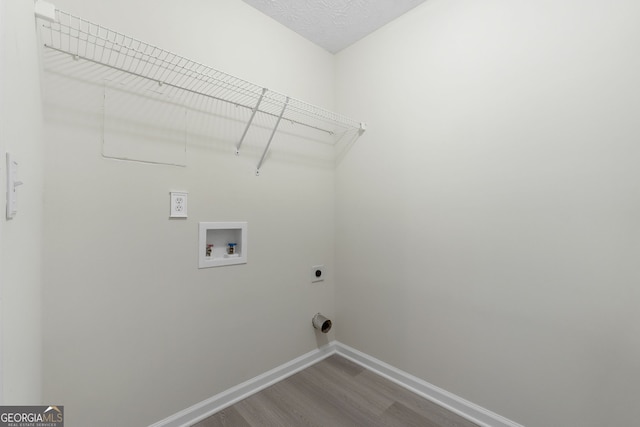 washroom featuring laundry area, washer hookup, baseboards, dark wood finished floors, and electric dryer hookup