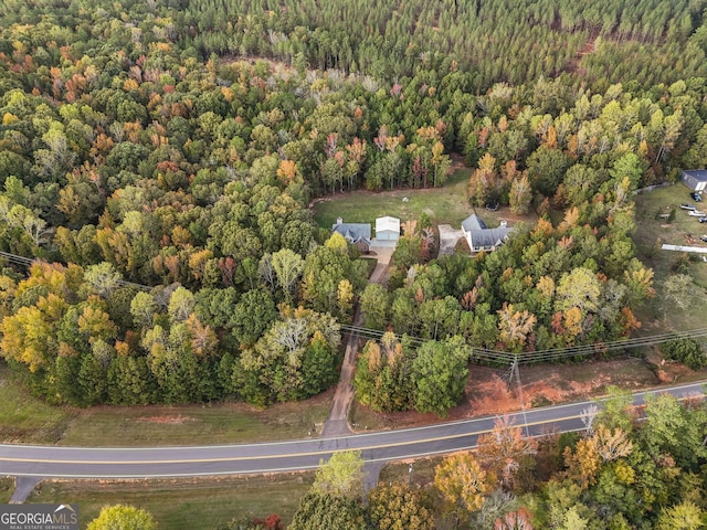 birds eye view of property featuring a wooded view