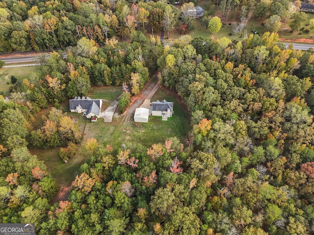 drone / aerial view featuring a wooded view