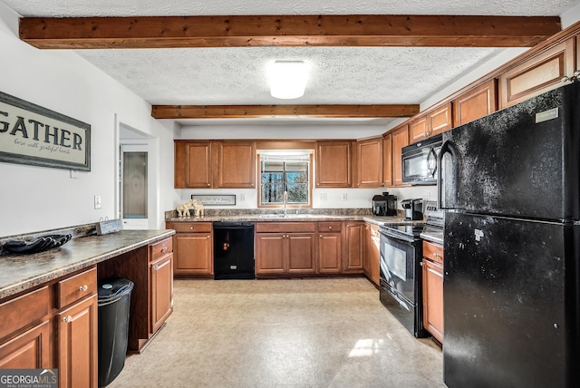 kitchen featuring black appliances, a textured ceiling, brown cabinetry, and beam ceiling