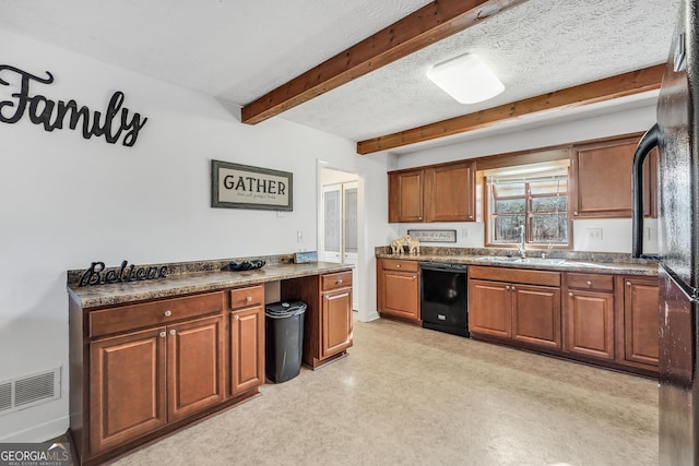 kitchen featuring a textured ceiling, light floors, brown cabinetry, black appliances, and beamed ceiling