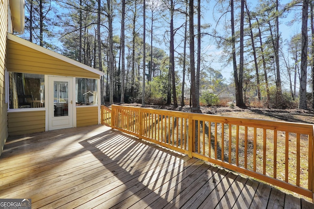 wooden deck with a sunroom