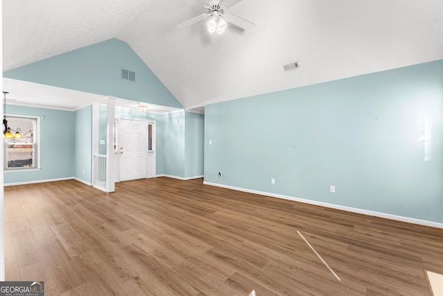 unfurnished living room featuring visible vents, wood finished floors, a ceiling fan, and baseboards