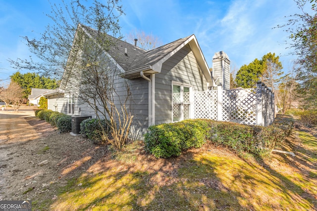 view of side of home featuring a chimney